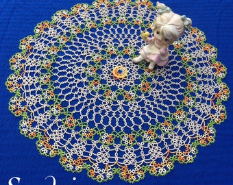 Large round tatted doily. Made in 40 vintage threads. 44cm/17.5inches across. Ecru, green & variegated orange colours. Prize winning.
