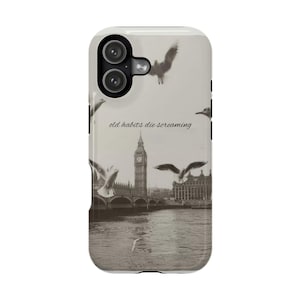 May include: A phone case featuring a sepia-toned image of London's Big Ben and the Houses of Parliament, with seagulls in flight. The text "old habits die screaming" is printed on the case.