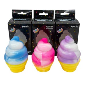 May include: Three colorful ice cream cone sensory toys. Each cone has a yellow base and a swirl of blue and white, pink and white, or purple and white. The boxes behind the toys read "Nice Cream Sensory Toy" and "Ages 3+".