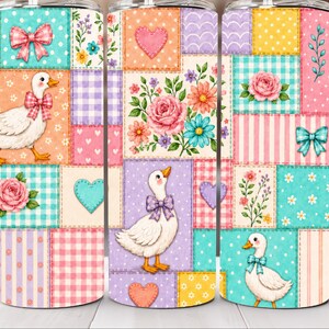May include: A cylindrical tumbler featuring a colorful patchwork design with white ducks wearing bows, pink roses, blue and pink hearts, and various floral patterns in shades of teal, yellow, orange, and purple on a repeating grid background.