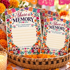 May include: Two rectangular paper cards for writing memories, featuring colorful floral borders, sugar skulls, candles, and the text Share a MEMORY Write a special memory of your loved one DÍA DE LOS MUERTOS in a festive, decorative style.