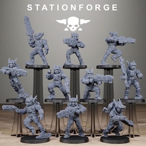 May include: A collection of ten grey resin miniature figures from StationForge, each depicting a futuristic soldier in tactical armor holding various sci-fi rifles and blasters, displayed on individual black circular stands.