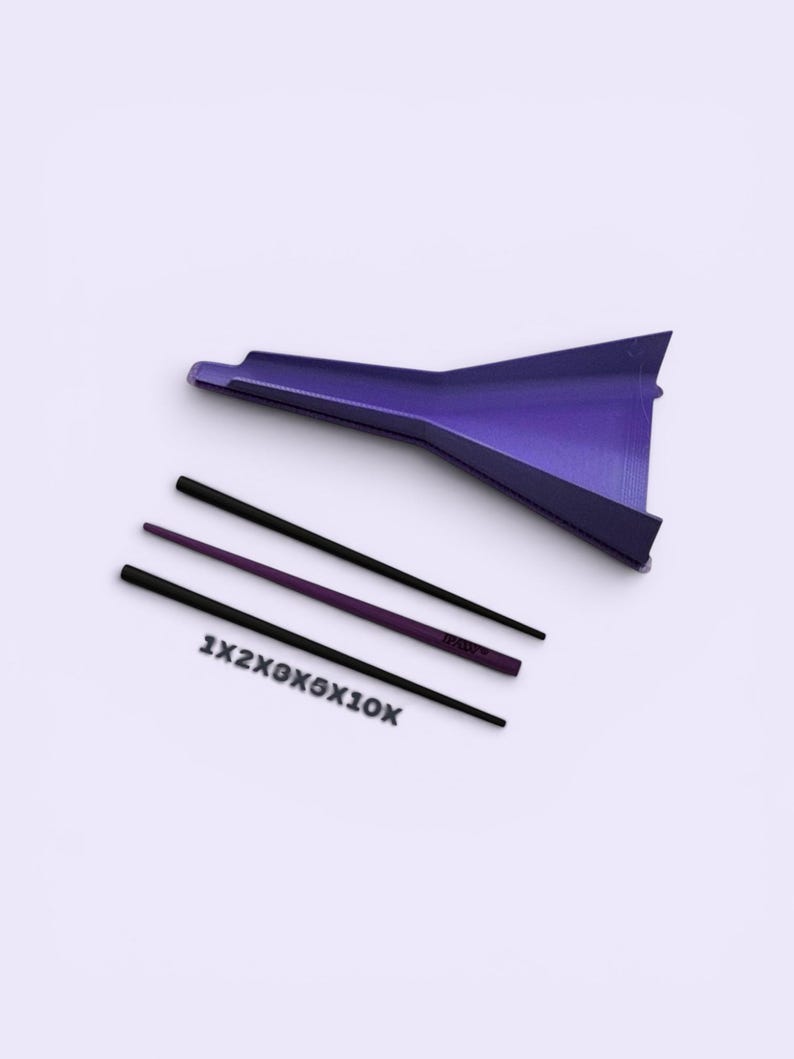 May include: A purple funnel-shaped tool accompanied by two thin, straight rods, one black and one purple, and a set of black plastic letters and numbers arranged in a row that read 1X2X3X5X10X, all presented against a plain, light-coloured background.