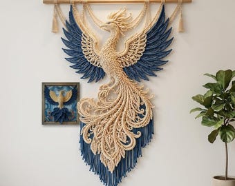 May include: A large macrame wall hanging featuring a cream and blue phoenix bird design suspended from a wooden rod, accompanied by a smaller square framed artwork depicting a similar phoenix motif in matching cream and blue fiber art textures.
