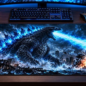 May include: A rectangular desk mat featuring a detailed graphic illustration of a giant monster emitting a bright blue energy beam from its mouth. The scene depicts a dark, stormy city landscape with crumbling buildings, explosions, and helicopters.