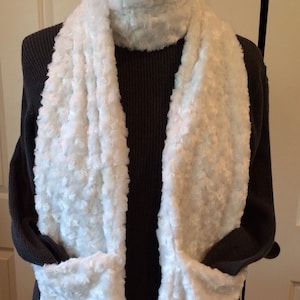 Cozy swirl faux fur pocket scarf will keep you and your hands warm too.