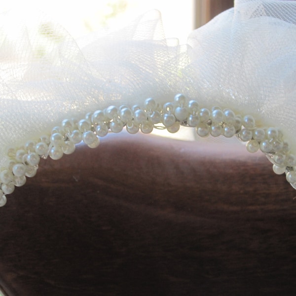 Ivory pearl headpiece and 32" cascade cut edged veil.