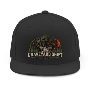 May include: A black baseball cap featuring a graphic of a skull wearing a tactical helmet with night vision goggles. The design includes a forest, a crescent moon, and the text GRAVEYARD SHIFT and HOLD THE LINE in a beige font color.