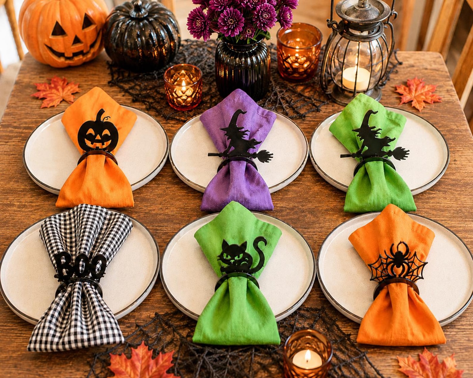A Different Silhouette at Each Place Six plates with gathered cloth napkins held by different Halloween silhouette rings.