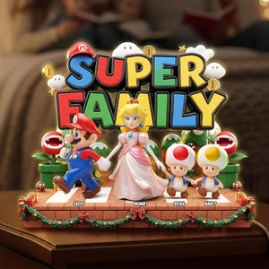May include: A decorative display featuring Mario, Princess Peach, and two Toads standing on a brick-patterned base. The text SUPER FAMILY is displayed above the figures. The base includes the names DADDY, MOMMY, BRIAN, and NANCY with Christmas garland.