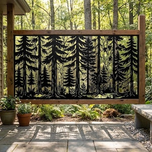 May include: A rectangular black metal privacy screen featuring a laser-cut forest design with various pine trees, foliage, and tree trunks. The panel is mounted within a wooden frame, displaying a detailed silhouette of a dense woodland scene.