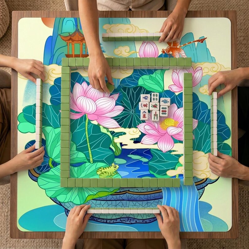 Overhead view of four players using the lotus pond mahjong mat, with green tiles arranged around the central pink lotus illustration.