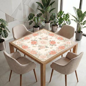 Peony mahjong table mat covering a square table in a modern room, with neutral chairs and tall potted plants near large windows.