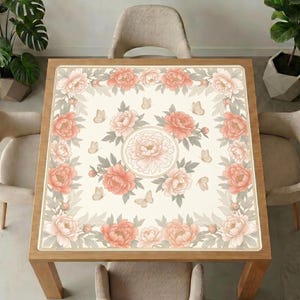 Peony mahjong table mat laid on a square wooden table, surrounded by beige upholstered chairs and green indoor plants.