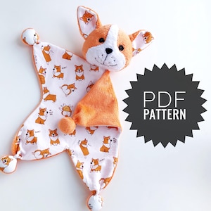 Könnte beinhalten: Ein Plüsch-Baby-Kuscheldecke in Form eines orange-weißen Corgi-Hundes mit einem gemusterten Stoff mit Corgi-Illustrationen. Die Decke hat ein weiches, strukturiertes orangefarbenes Dreieck und Bommel. Das Bild enthält einen schwarzen Stern mit dem Text "PDF PATTERN".