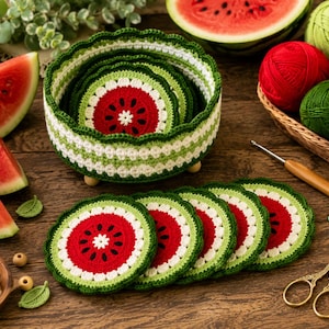 May include: A round, crocheted basket with a watermelon pattern in red, white, and green, containing matching circular coasters. The set features a scalloped edge design, with additional coasters arranged in a row, alongside yarn balls, a crochet hook, and scissors.