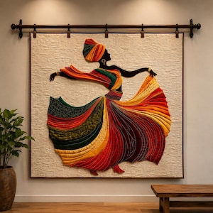 May include: A large square wall hanging featuring a quilted fabric applique of a dancing figure. The figure wears a vibrant, multi-colored skirt in shades of red, orange, yellow, and green, with a matching headwrap, suspended from a dark metal rod.