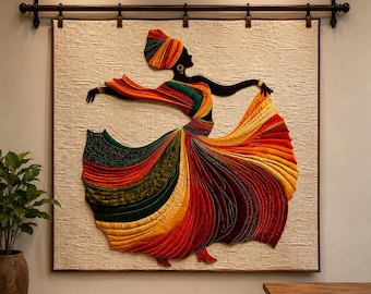 May include: A large square wall hanging featuring a quilted fabric applique of a dancing figure. The figure wears a vibrant, multi-colored skirt in shades of red, orange, yellow, and green, with a matching headwrap, suspended from a dark metal rod.