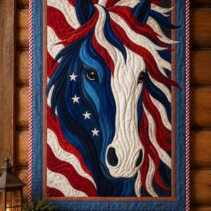 May include: A rectangular fabric wall hanging featuring a stylized horse head in red, white, and blue. The horse has a flowing mane and a blue face adorned with white stars. The background consists of wavy red and white stripes.