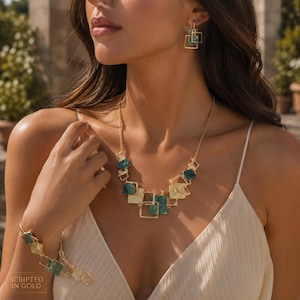 May include: A gold-toned jewellery set consisting of a necklace, a bracelet, and earrings. Each piece features a series of interconnected square frames, some with a textured gold finish and others containing deep teal, square-shaped stone inlays.