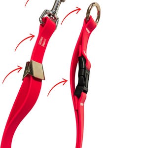 May include: A bright red dog leash with a silver metal clasp and a black plastic buckle. The leash is made of a flexible, durable material and features a metal ring at the handle end.