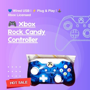 May include: A blue translucent wired USB Xbox Rock Candy controller in its original packaging. The controller features white analog sticks, a white directional pad, and colored A, B, X, and Y buttons. Text on the image includes Wired USB, Plug & Play, Xbox Licensed, and Xbox Rock Candy Controller.
