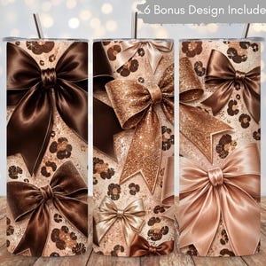 May include: A cylindrical tumbler featuring a pattern of brown and tan leopard spots interspersed with various large bows in shades of dark brown, metallic gold, and light beige. A thin metal straw protrudes from the top. Text reads 6 Bonus Design Included.