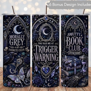 May include: A cylindrical tumbler with a straw featuring a dark blue and purple gothic design. The print includes ravens, butterflies, books, an hourglass, and text reading Morally Grey Is My Favorite Color, You Had Me At Trigger Warning, and Smutty Book Club.