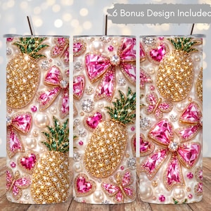 May include: A cylindrical tumbler with a straw featuring a repeating pattern of gold jeweled pineapples, pink crystal bows, pink crystal hearts, pink crystal butterflies, and white pearls. The text 6 Bonus Design Included is visible.