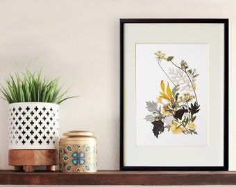 May include: A framed pressed flower art print with a white mat and black frame. The print features a bouquet of dried flowers in shades of yellow, white, and green.