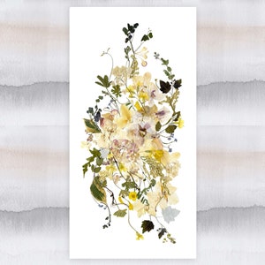May include: A pressed flower arrangement featuring a variety of dried flowers in shades of yellow, white, and purple. The flowers are arranged in a loose, cascading style, creating a delicate and romantic look.