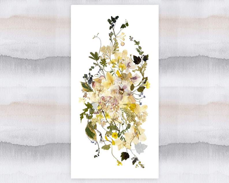 May include: A pressed flower arrangement featuring a variety of dried flowers in shades of yellow, white, and purple. The flowers are arranged in a loose, cascading style, creating a delicate and romantic look.