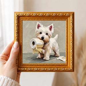 May include: An oil painting in a decorative gold frame depicting a white West Highland White Terrier puppy holding a roll of toilet paper in its mouth, with loose paper scraps on the floor against a neutral gray background.