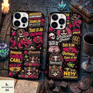 May include: Two black smartphone cases featuring vibrant, colorful graphic prints of cats, dinosaurs, skulls, and text including "Neeeeeeew Achievement," "This Is An Outrage," "Princess Posse," "Dungeon Crawler Carl," and "New Achievement."