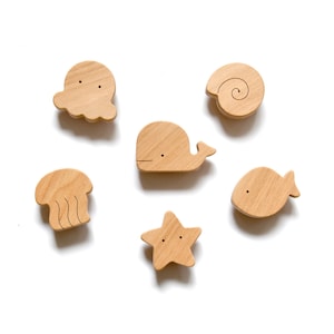 Ocean-themed nursery knobs for the dresser. Perfect for other kids' furniture drawers, and cabinet doors.
The set of 6 marine characters includes:
Octopus, Whale, Fish, Sea Star, Jellyfish, and Shell.