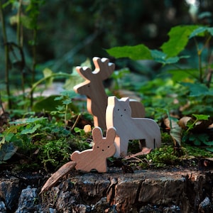 wooden animal figures in forest