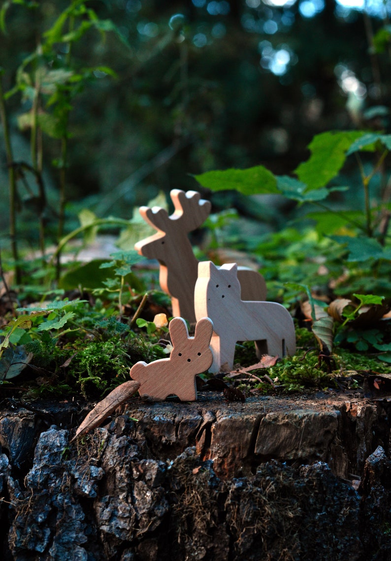 wooden animal figures in forest