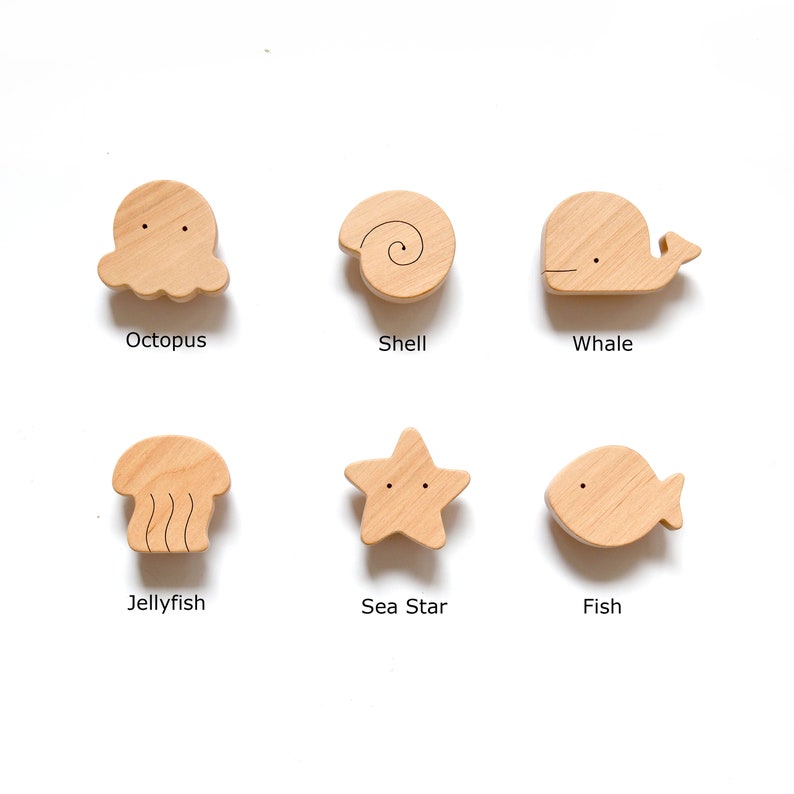 An exclusive design, ocean-themed set of 6 knobs for baby dresser or cabinet. 
These cute and functional natural wood knobs will become a playful and unique accent in the nursery. The set feature Octopus, Whale, Fish, Sea Star, Jellyfish, and Shell.