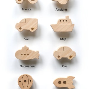 8 vehicle wall hooks including Car, Van, Tractor, Airplane, Ship, Submarine, Rocket, and Hot Air Balloon.