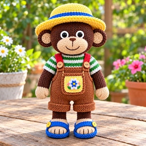 May include: A knitted monkey doll wearing a yellow straw-style hat with a blue band, a green and white striped shirt, and brown overalls featuring a yellow pocket with a white and blue flower embroidery. The doll wears blue sandals with yellow buttons.