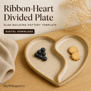 May include: A heart-shaped ceramic divided plate with a speckled beige finish and brown rim. The plate contains five blueberries on the left side and two small round biscuits on the right side. Text reads: Ribbon-Heart Divided Plate, SLAB-BUILDING POTTERY TEMPLATE, DIGITAL DOWNLOAD, DiyWhisperCo.