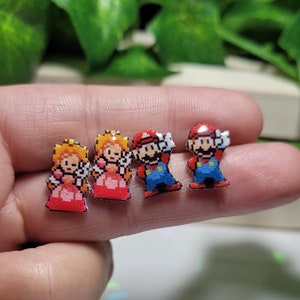 Princess and Plumber victory pose Video game studs// Stainless steel, resin, plastic.