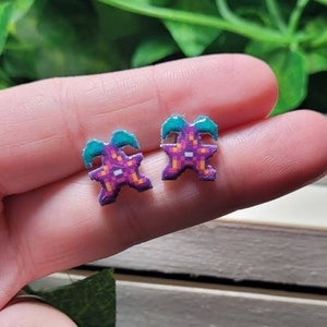 Stardrop fruit stud earrings from Stardew Valley.// Stainless steel, resin, plastic.