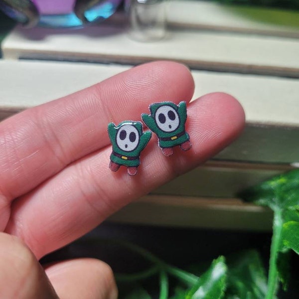 Video game, green guy stud earrings// Stainless steel, resin, plastic.