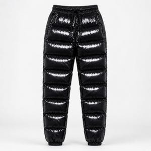 May include: Black quilted puffer pants with a high-shine, glossy finish. These trousers feature horizontal stitched baffles, an elasticized waistband with a matching black drawstring cord, and gathered elastic cuffs at the bottom of each leg.