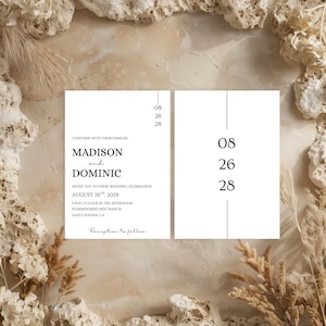May include: Two white rectangular wedding invitation cards with black serif and script text. The left card displays the names Madison and Dominic, the date August 26, 2028, and event details. The right card features the date 08 26 28 vertically.