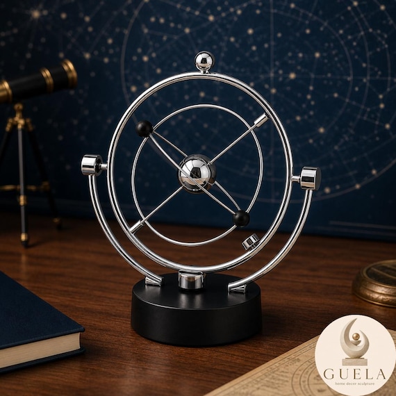 A polished silver orbital kinetic sculpture that mimics planetary motion on your desk — satisfying to watch and genuinely officeworthy.