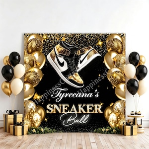 May include: A black and gold backdrop featuring a pair of high-top sneakers, gold and black balloons, and the text Tyreeana's SNEAKER Ball. The design includes gold glitter accents and a dark background, creating a festive display for an event.