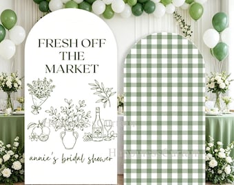 May include: Two arched backdrop covers. The left cover is white with the black text FRESH OFF THE MARKET and annie's bridal shower, featuring line art of flowers, fruit, a vase, and a wine bottle. The right cover features a green and white gingham pattern.