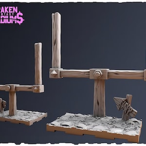 May include: Two miniature goalposts with a light brown wood-grain texture, mounted on rectangular bases with a textured ground surface. The text KRAKEN FANTASY STADIUMS appears in pink in the upper left corner. A small wooden signpost is attached.